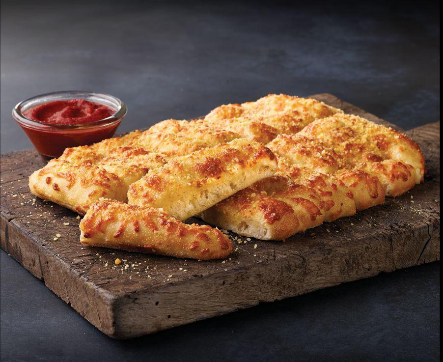 Cheesy Bread · Fresh baked bread strips with our three cheese blend and garlic butter served with a side of pizza sauce and ranch dipping sauce.   Optional additional sauces include Jalapeno Ranch, Blue Cheese, and Garlic Butter.