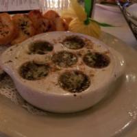 Escargot · Garlic parsley butter and toast points.