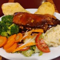 Baby Back BBQ Ribs · Served with mashed potatoes, garlic bread and your choice of soup or salad.