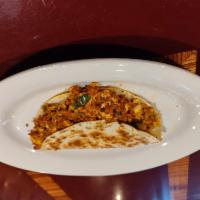 Mexican Breakfast Quesadilla · Chorizo, eggs, jalapenos, cilantro, onions, tomatoes, beans, cheese and avocado with a side ...