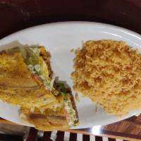 Jibarito Sandwich · Fried plantain sandwich with ribeye steak, onions, tomatoes, lettuce, mayo and rice on the s...