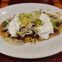 Huaraches Steak · Contains beans, lettuce, tomato, cheese, onions, sour cream and filled with carne asada.