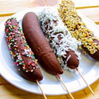 Banana Dippers · Banana dipped in chocolate and topping of your choice: plain, coconut, peanuts, or sprinkles.