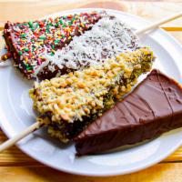 Cheesecake Dippers · Cheesecake dipped in chocolate and topping of your choice: plain, coconut, peanuts, or sprin...