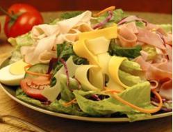 Chef Salad · Romaine hearts, tomatoes, purple cabbage, carrots, cucumbers and egg topped with turkey and ...