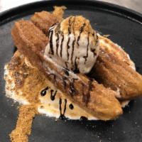 Smores Chocolate Churro Sundae · Toasted marshmallow, graham dust and black walnut ice cream.