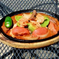 Fajitas Mixtas · Shrimp, chicken and beef.  Served with sauteed onion, bell pepper and tomatoes, accompanied ...