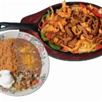 Chicken & Steak Combo Fajita · Chicken and Steak, grilled with fresh bell peppers, onions, and spices. Served with refried ...