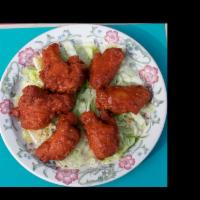 Spicy Buffalo Wings · Cooked wing of a chicken coated in sauce or seasoning.
