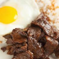 Tapsilog · Marinated cured beef, garlic rice, and eggs.