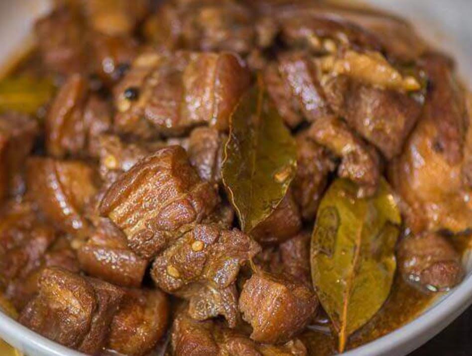 Adobo Pork · Pork braised in soy sauce, vinegar, garlic with whole black pepper, onions, and bay leaves.