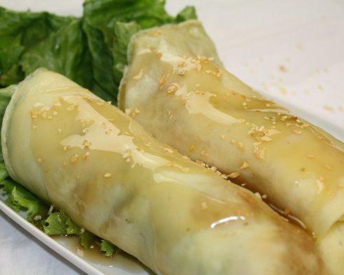 Lumpiang Sariwa · 2 pieces. Mixed vegetable crepe topped with peanut sauce.
