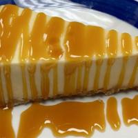 caramel topping over cheesecake · New York style cheesecake on top of a graham cracker crust. topped with caramel  topping.