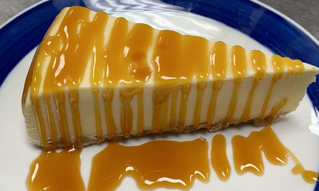 caramel topping over cheesecake · New York style cheesecake on top of a graham cracker crust. topped with caramel  topping.