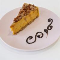 Pumpkin Cheesecake Slice · Pumpkin cheesecake with a praline glazed drizzle on top.