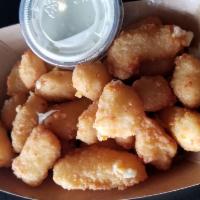 Fried Cheese Curds · Breaded Wisc. white cheddar curds served with ranch.