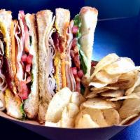 Turkey Club · Double-decker TX Toast sandwich stuffed with turkey, bacon, cheddar, lettuce, tomato, mayo &...