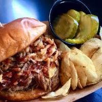 Pulled Pork Sandwich · Braised Pulled Pork & crunchy fried onions with BBQ sauce on a brioche bun with a side of pi...