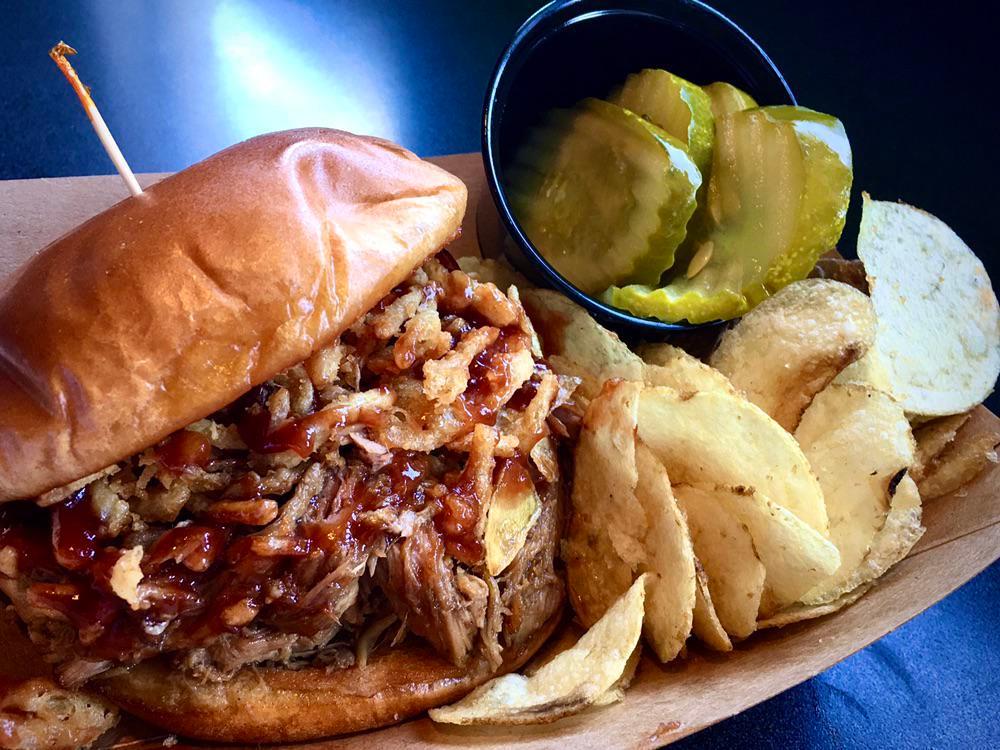 Pulled Pork Sandwich · Braised Pulled Pork & crunchy fried onions with BBQ sauce on a brioche bun with a side of pickles