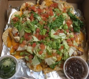 Loaded Nachos · Refried beans, onions, cheddar & pepper jack, lettuce, tomato and your choice of chicken, shredded steak or ground beef, jalapenos and salsa served on the side.