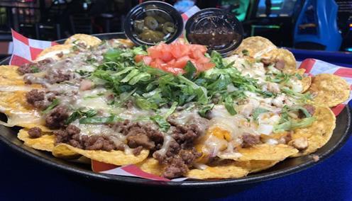 Loaded Nachos · Refried beans, onions, cheddar & pepper jack, lettuce, tomato and your choice of shredded steak or ground beef, jalapenos and salsa served on the side.