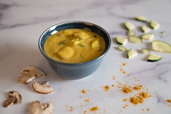 Coconut Curry Soup · Made with fresh young Thai coconut meat, warming spices, and fresh zucchini and mushrooms.  For a heartier warm grain bowl version, see “Flourish”.