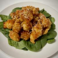 Sesame Chicken · Marinated chicken lightly battered and fried drizzled in homemade sweet-sauce sauce,
with as...