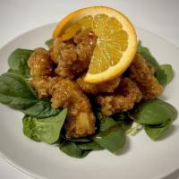 Orange Chicken · Marinated chicken lightly battered and fried drizzled in homemade orange sauce,
with assorte...