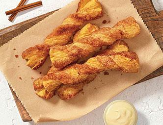 Cinnabon Stix® (10 ct) · Twisted fresh-baked Danish dough coated with buttery vanilla goodness and covered in sugar and Makara® Cinnamon.