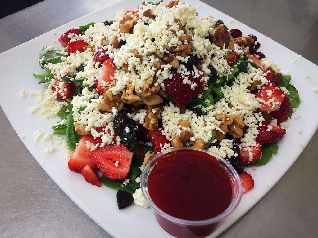 Spinach Salad · Spinach, walnuts, cranberries, strawberries, raisins and topped with feta and raspberry vinaigrette.