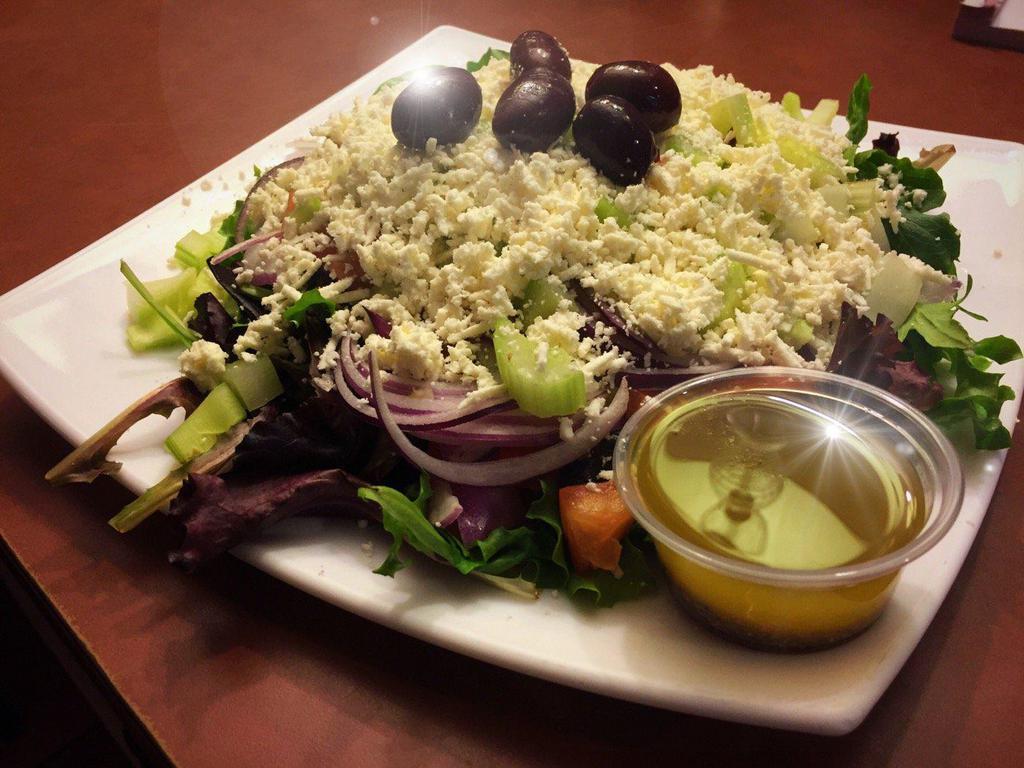 Greek Salad · Mixed greens, cucumbers, grape tomatoes, red onions, Kalamata olives, bell peppers, topped with feta and tossed with homemade Greek dressing