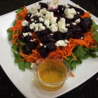 Roasted Beet Salad · Roasted beets, goat cheese, curly carrots and almonds on a bed of arugula, drizzled in balsa...