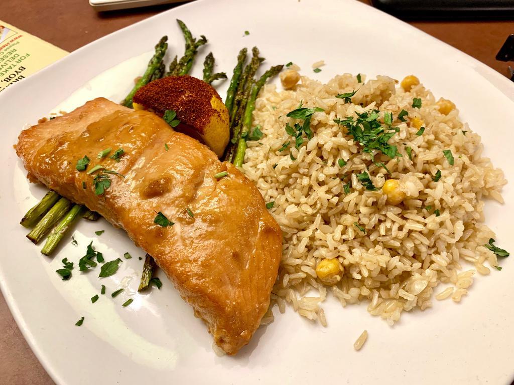 Miso Salmon · Baked miso marinated salmon served with organic brown rice and grilled asparagus, topped with homemade garlic pesto.