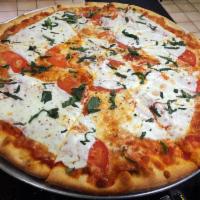 Margherita Pizza · Fresh mozzarella, sliced tomatoes and fresh basil.