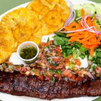 72. Entraña al Chupiniki con Pico de Gallo · Grilled skirt steak with pico de gallo, salad & green plantain.