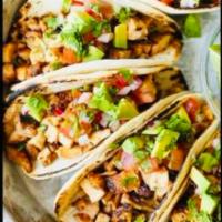 Chicken tacos  · Served with fresh cilantro, pico de gallo, roasted corn, tortilla chips and homemade guacamo...