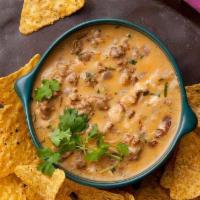 Queso Fundido · Our rich cheese dip blended with taco seasoning and our in-house salsa.  Served with corn to...