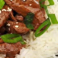 Beef over Rice · Pan seared thinly sliced strips of seasoned beef served over a bed of jasmine rice.  Garnish...
