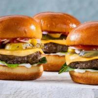 The American Sliders · Two sliders made with all beef patties, seasoned, and topped with American cheese, lettuce, ...