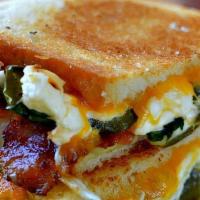 Jalapeño Popper Grilled Cheese · Gooey, melty Cheddar and cream cheese on sourdough bread piled high with blistered jalapeños...
