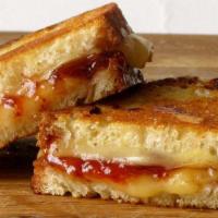An Apple a Day Grilled Cheese · Pepper Jack and Cheddar cheeses melted between red pepper jelly, apple slices and caramelize...