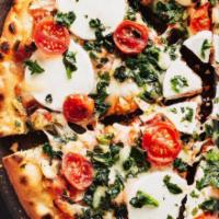 Goat Cheese Flatbread  · delectable wood-fired crust, this pizza is topped with grade tomatoes, sliced goat cheese, s...