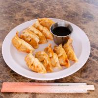 Gyoza Plate · Served with salad and steamed rice.