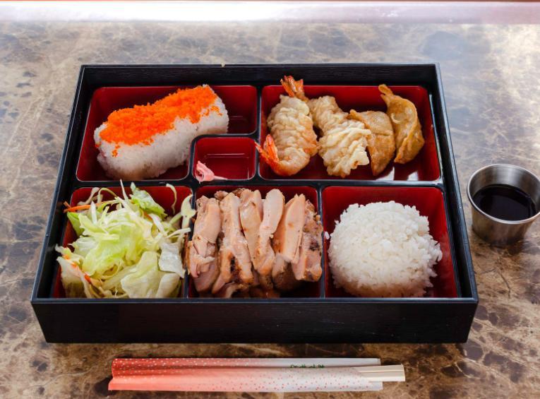 Bento A · Chicken teriyaki, shrimp tempura (2 pieces), gyoza (3 pieces), California roll (4 pieces), steamed rice and salad.