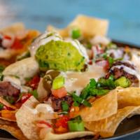 Nachos · Build your own Nachos. Queso comes on the side.