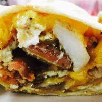 Breakfast Taco · Flour tortilla stuffed with scrambled egg, bacon or sausage, home fries or hash browns.