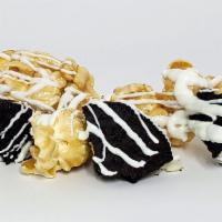 White Chocolate Oreo · Our scratch caramel with oreo cookie pieces, drizzled with our gourmet white chocolate.