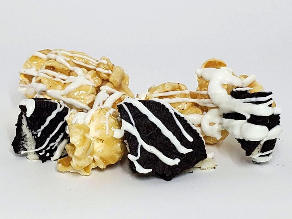 White Chocolate Oreo · Our scratch caramel with oreo cookie pieces, drizzled with our gourmet white chocolate.