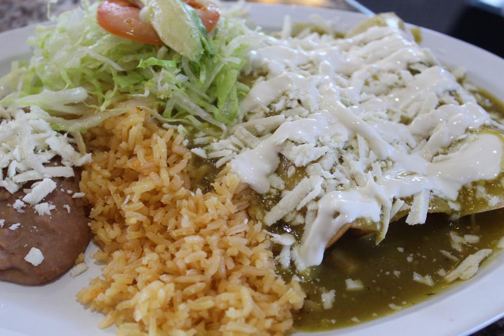 Enchilada Plate · 3 rolled corn tortillas with chicken sauce, cheese and sour cream, served with rice, beans and small salad.