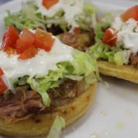Sopes · 3 deep-fried corn sopes topped with beans, meat of choice, lettuce, Mexican sour cream and s...